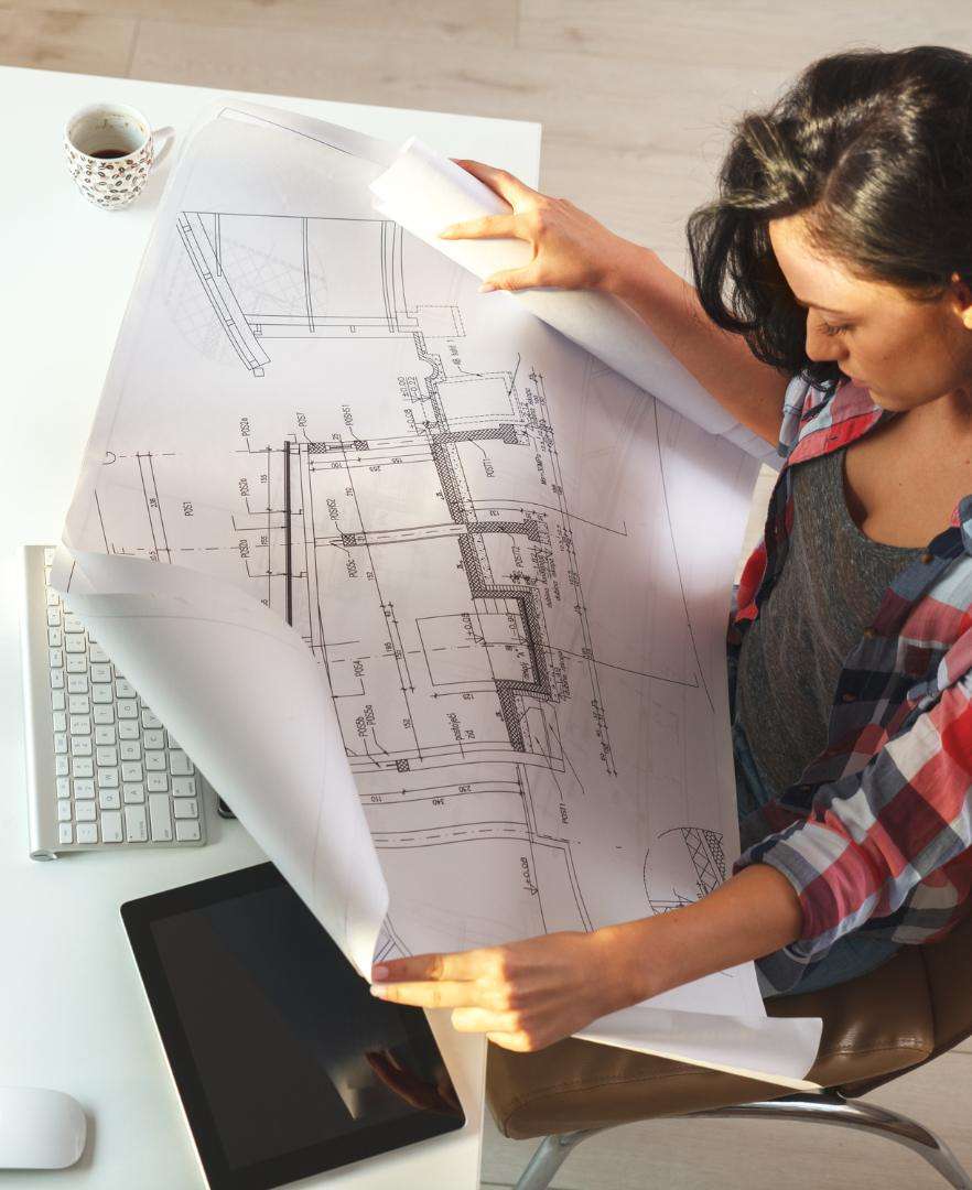 Architect reviewing plans for a custom parametric wall panel installation in Calgary.